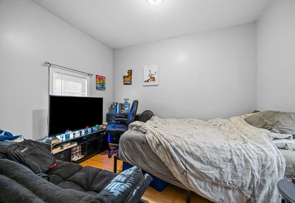 a bedroom with a bed and a flat screen tv