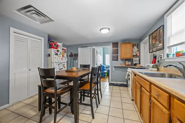 a view of a dining room with furniture and a chandelier