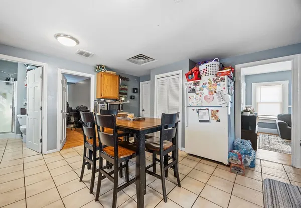a view of a dining room with furniture and chandelier