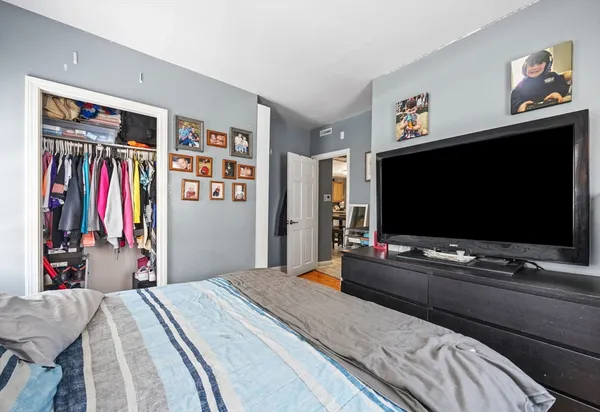 a bedroom with a bed and a flat screen tv