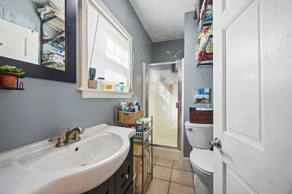 a bathroom with a sink mirror and a window