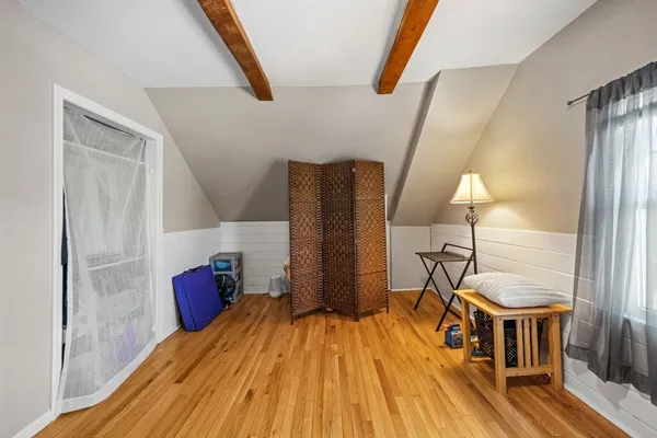 a view of a room with wooden floor and chair