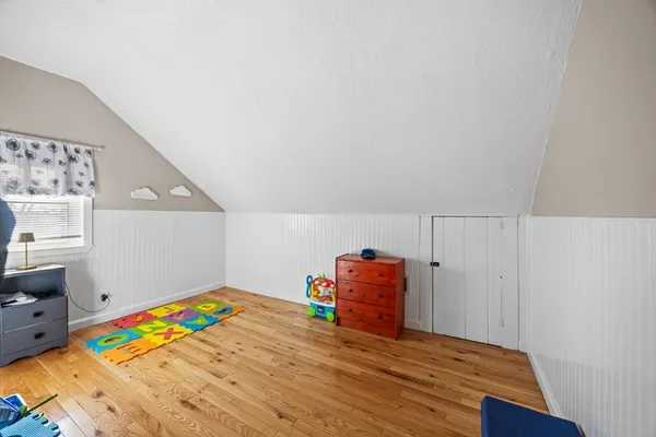 a bedroom with a bed and a dresser in it