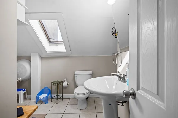 a bathroom with a sink toilet and a mirror