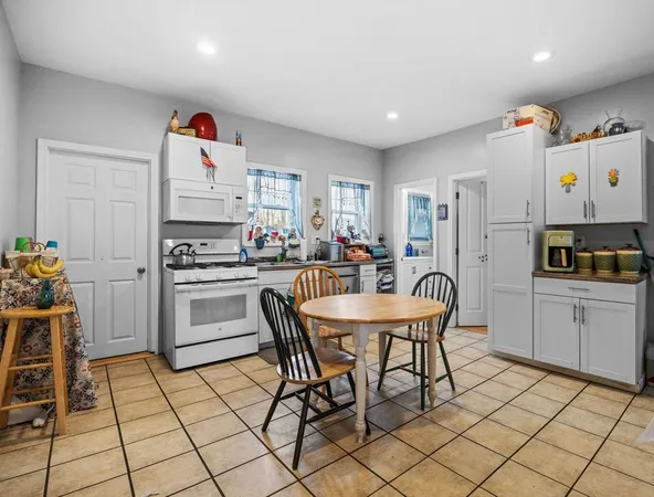 a kitchen with granite countertop a sink cabinets and stainless steel appliances