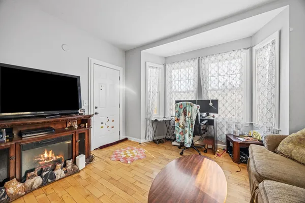 a bedroom with furniture and a flat screen tv