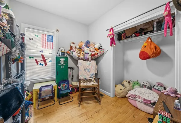 a bedroom with furniture and a flat screen tv