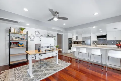 a living room with stainless steel appliances kitchen island granite countertop furniture and a dining table