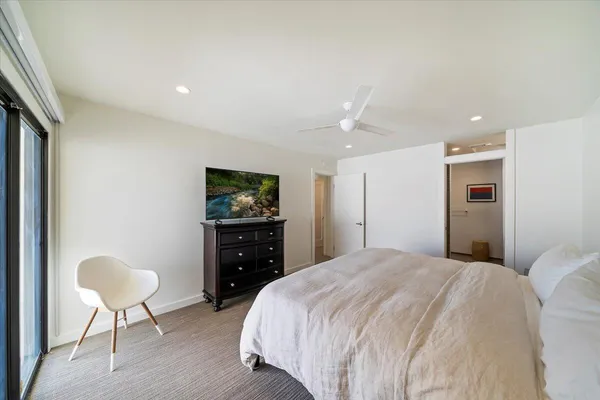 a bedroom with a bed and a chair
