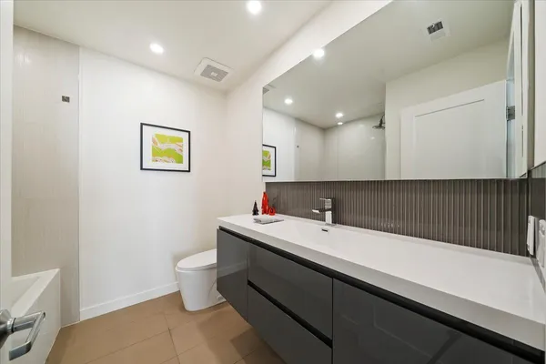 a bathroom with a sink a mirror and a toilet