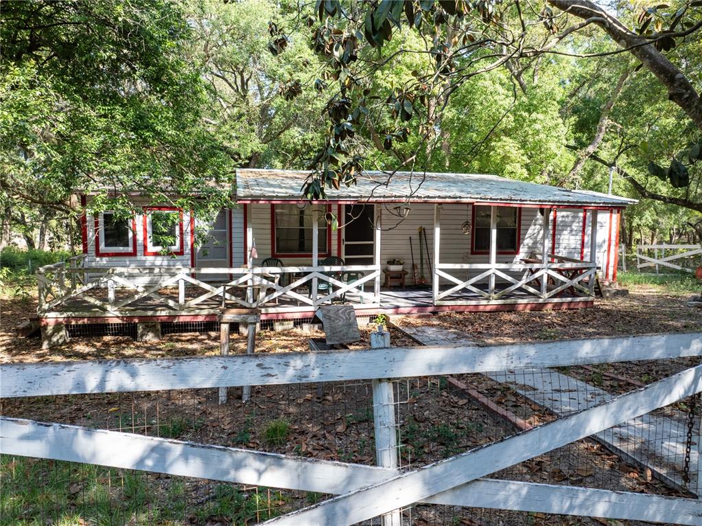 a front view of house with yard view and trees
