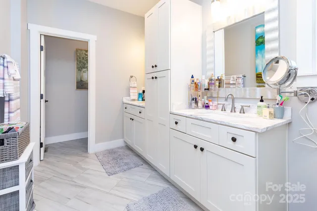 a bathroom with a sink vanity and mirror