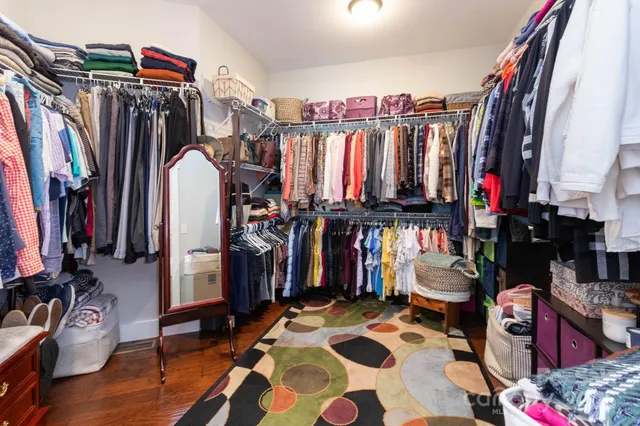 a view of walk in closet with clothes and shoes