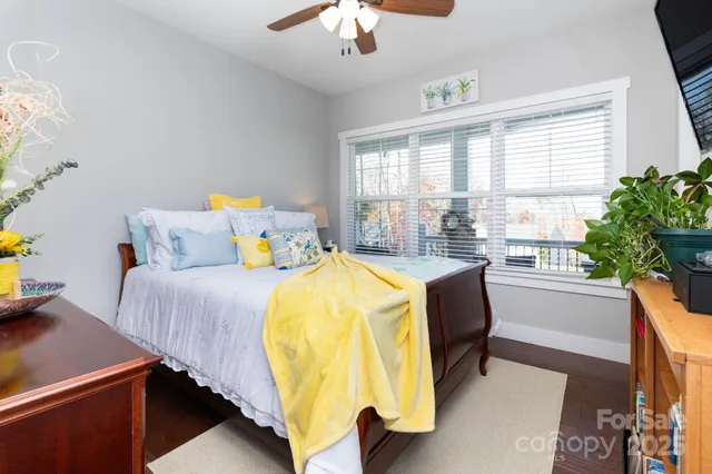 a bedroom with a bed and a chandelier