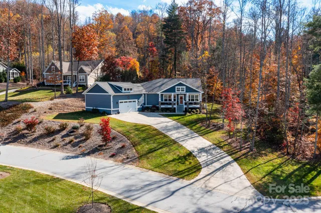 a view of a house with swimming pool and sitting area