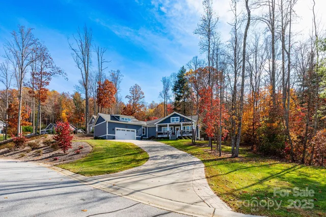 a view of swimming pool with outdoor seating and trees in the background