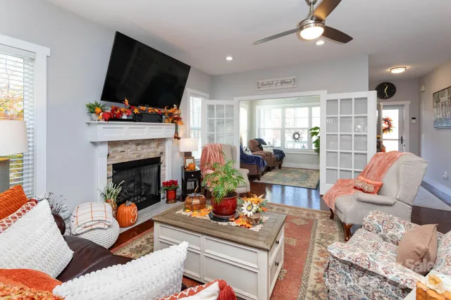 a living room with furniture a flat screen tv and a fireplace
