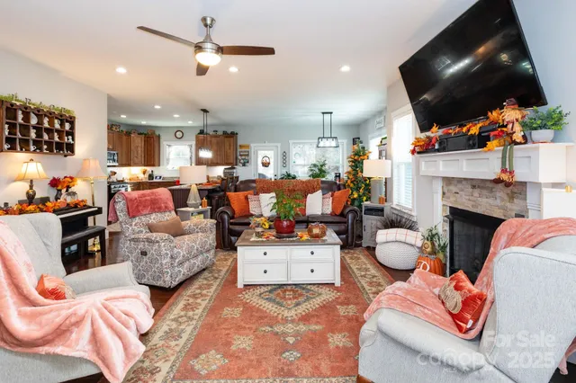 a living room filled with furniture a flat screen tv and a fireplace