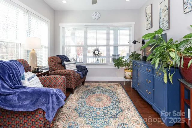 a living room with furniture and a potted plant