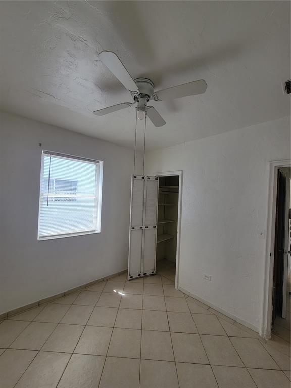 1824 Johnson Street Hollywood, FL 33020 - Photo 12 of 13 an empty room with a ceiling fan and carpet