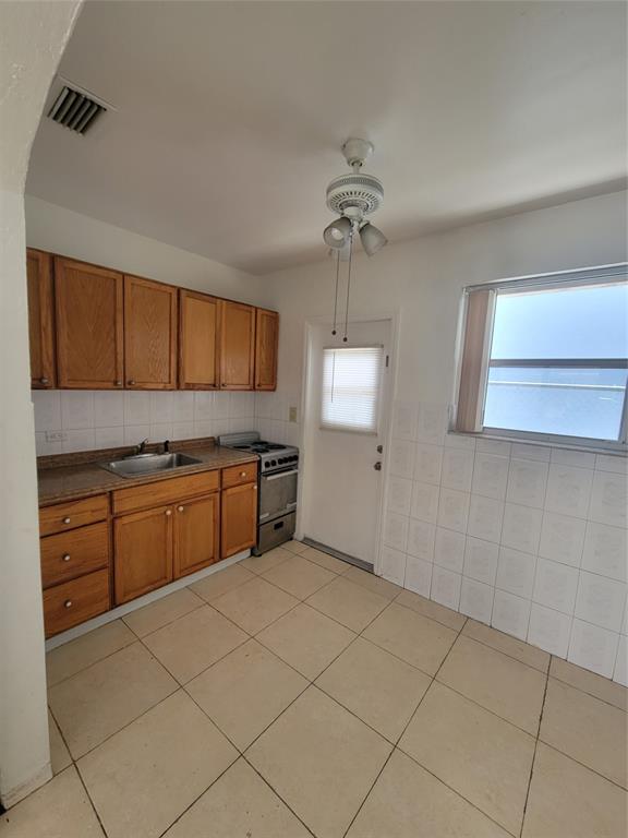 1824 Johnson Street Hollywood, FL 33020 - Photo 4 of 13 a kitchen with a stove cabinets and a sink