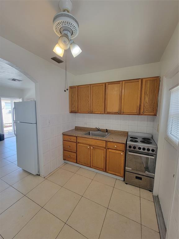 1824 Johnson Street Hollywood, FL 33020 - Photo 5 of 13 a kitchen with stainless steel appliances granite countertop a refrigerator a stove a sink and dishwasher