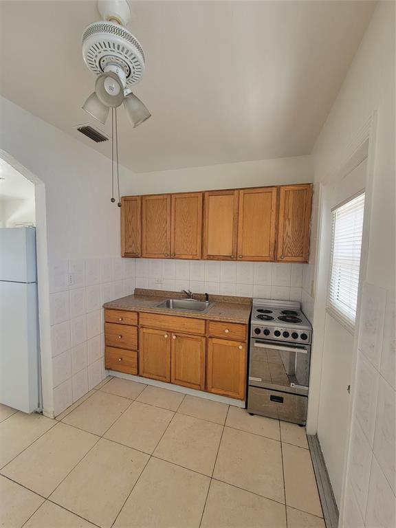 1824 Johnson Street Hollywood, FL 33020 - Photo 6 of 13 a kitchen with stainless steel appliances granite countertop a stove a sink and dishwasher