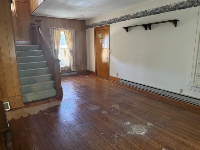 a room with wooden floor and a window