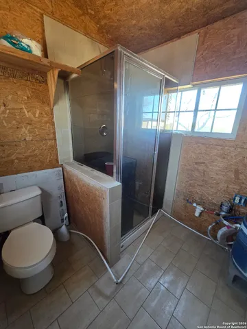 a bathroom with a toilet and a shower