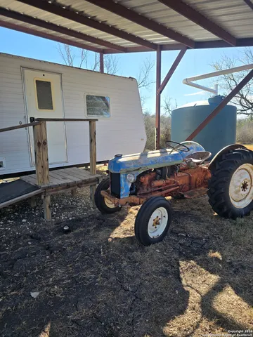 a view of a patio with table and chairs and couches with wooden floor