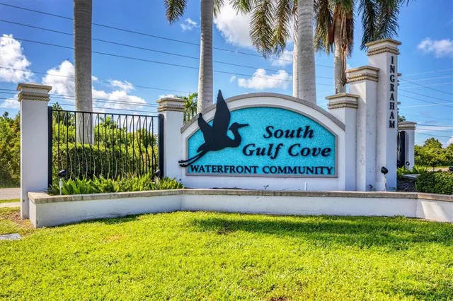 a sign board with a building in the background