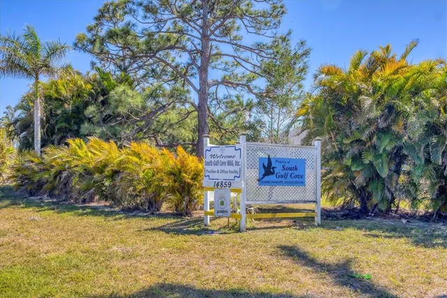 a view of a lake with a table and chairs