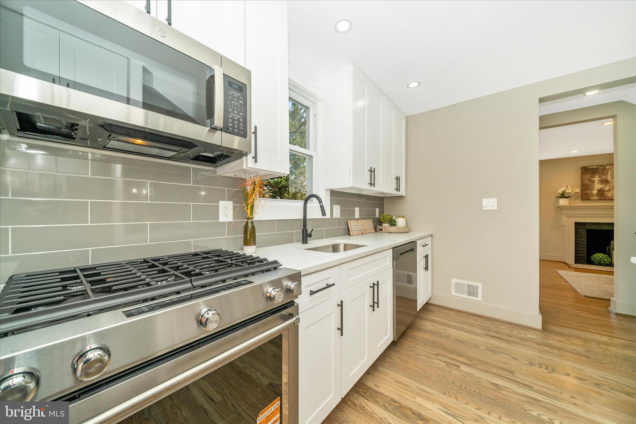 10405 Inwood Avenue Silver Spring, MD 20902 - Photo 14 of 52 a kitchen with stainless steel appliances a stove a sink and a microwave