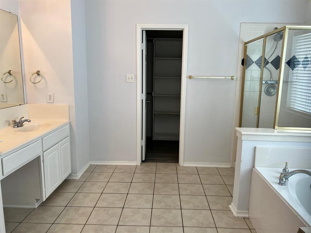4312 Ridge Point Lane Plano, TX 75024 - Photo 5 of 16 a bathroom with a sink a toilet and shower