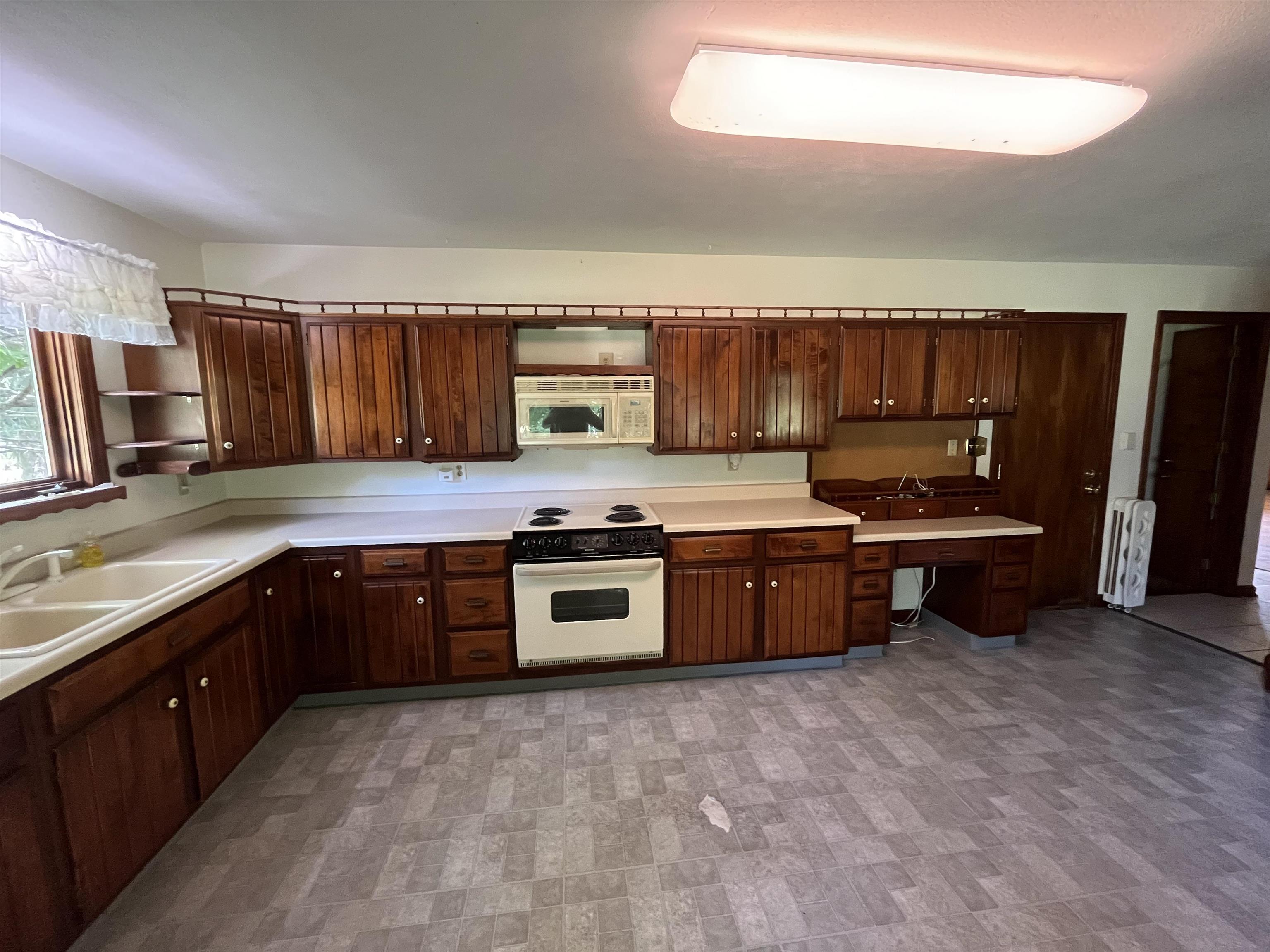 6816 Stardust Trail Roscoe, IL 61073 - Photo 11 of 21 a kitchen with stainless steel appliances a stove sink and cabinets