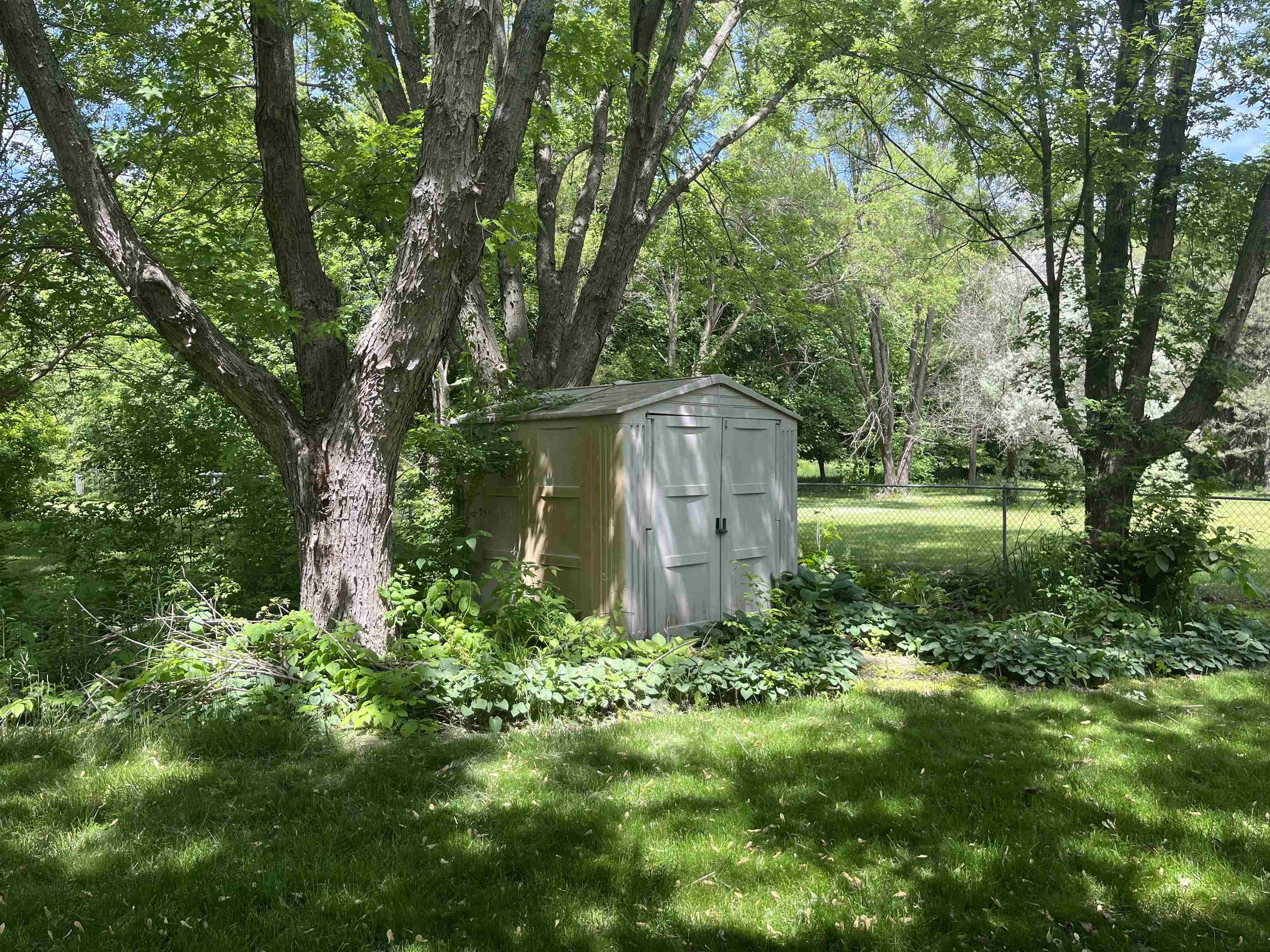 6816 Stardust Trail Roscoe, IL 61073 - Photo 19 of 21 a view of a garden with a bench