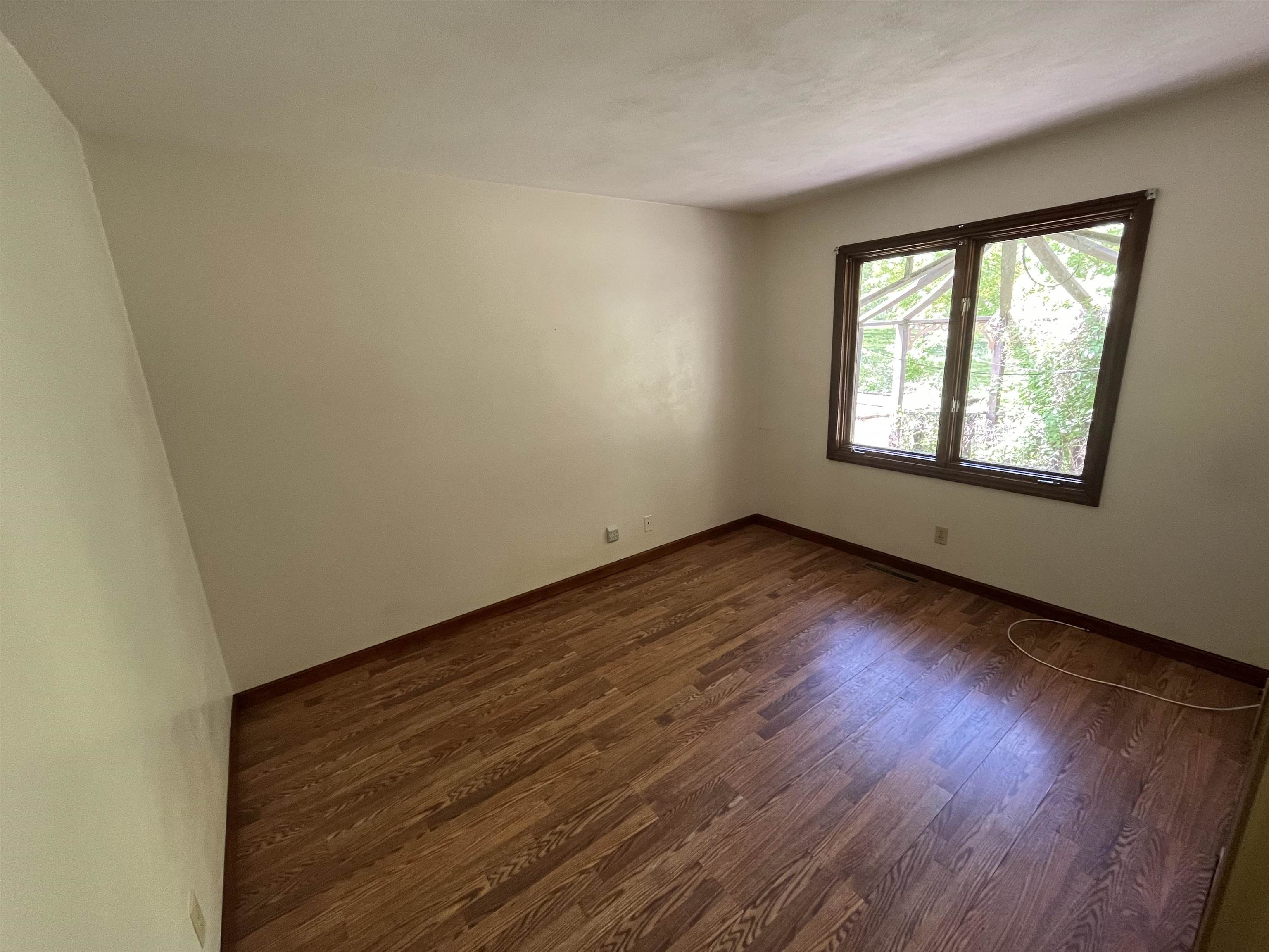 6816 Stardust Trail Roscoe, IL 61073 - Photo 6 of 21 an empty room with wooden floor and windows