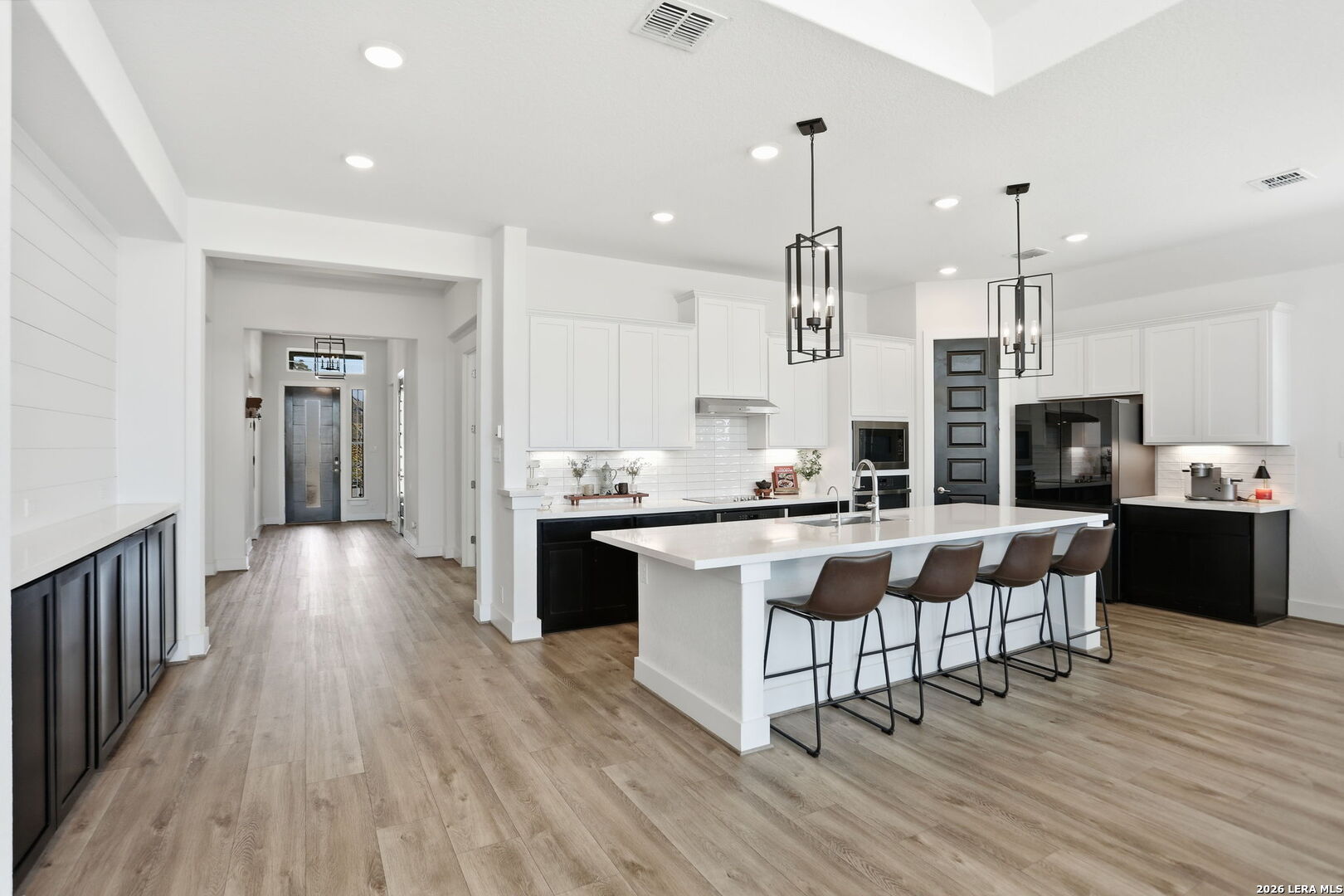 405 Corwin Cibolo, TX 78108 - Photo 14 of 46 a large kitchen with granite countertop a large counter top space a sink stainless steel appliances and cabinets