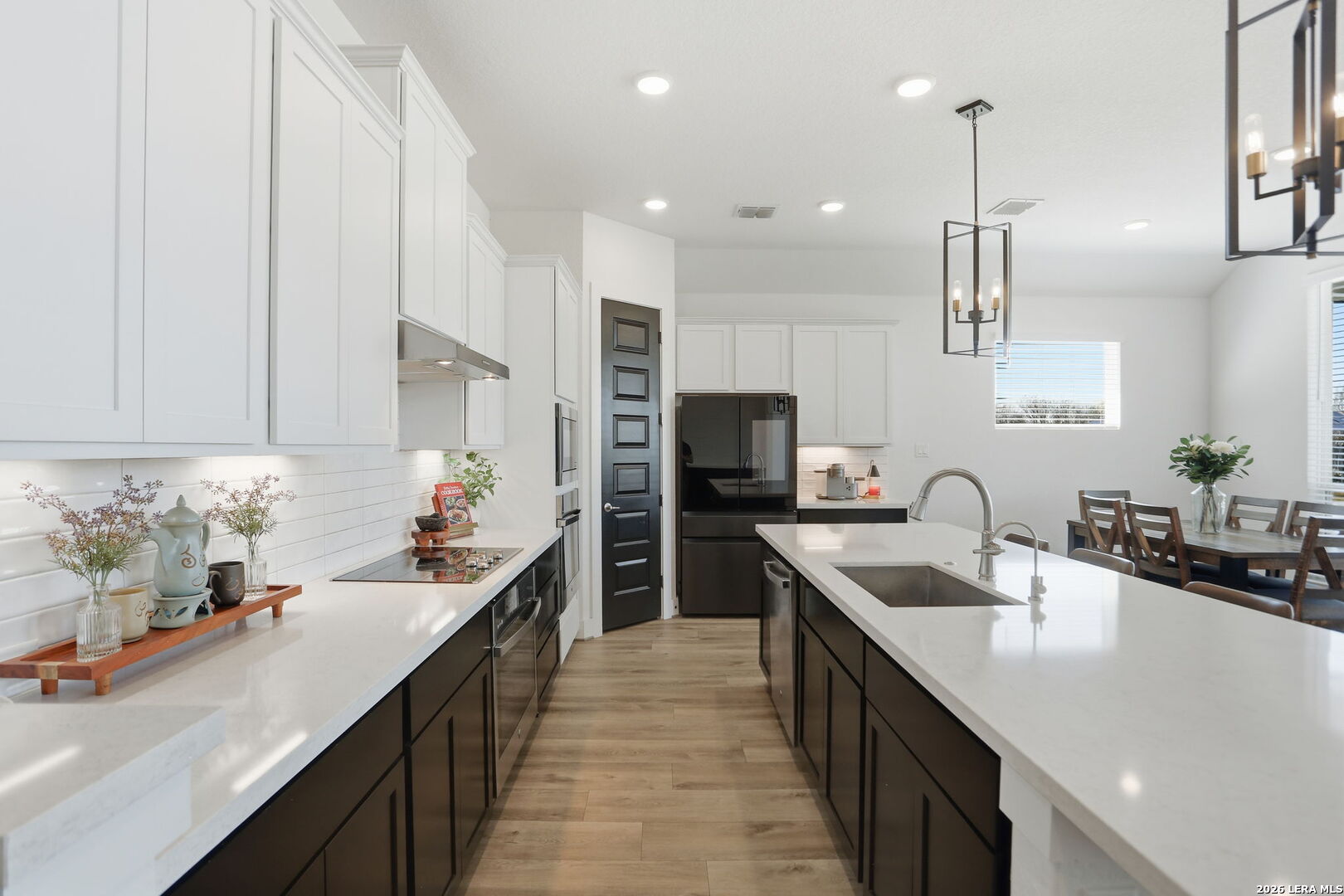 405 Corwin Cibolo, TX 78108 - Photo 16 of 46 a kitchen with kitchen island granite countertop a sink a counter top space stainless steel appliances and cabinets
