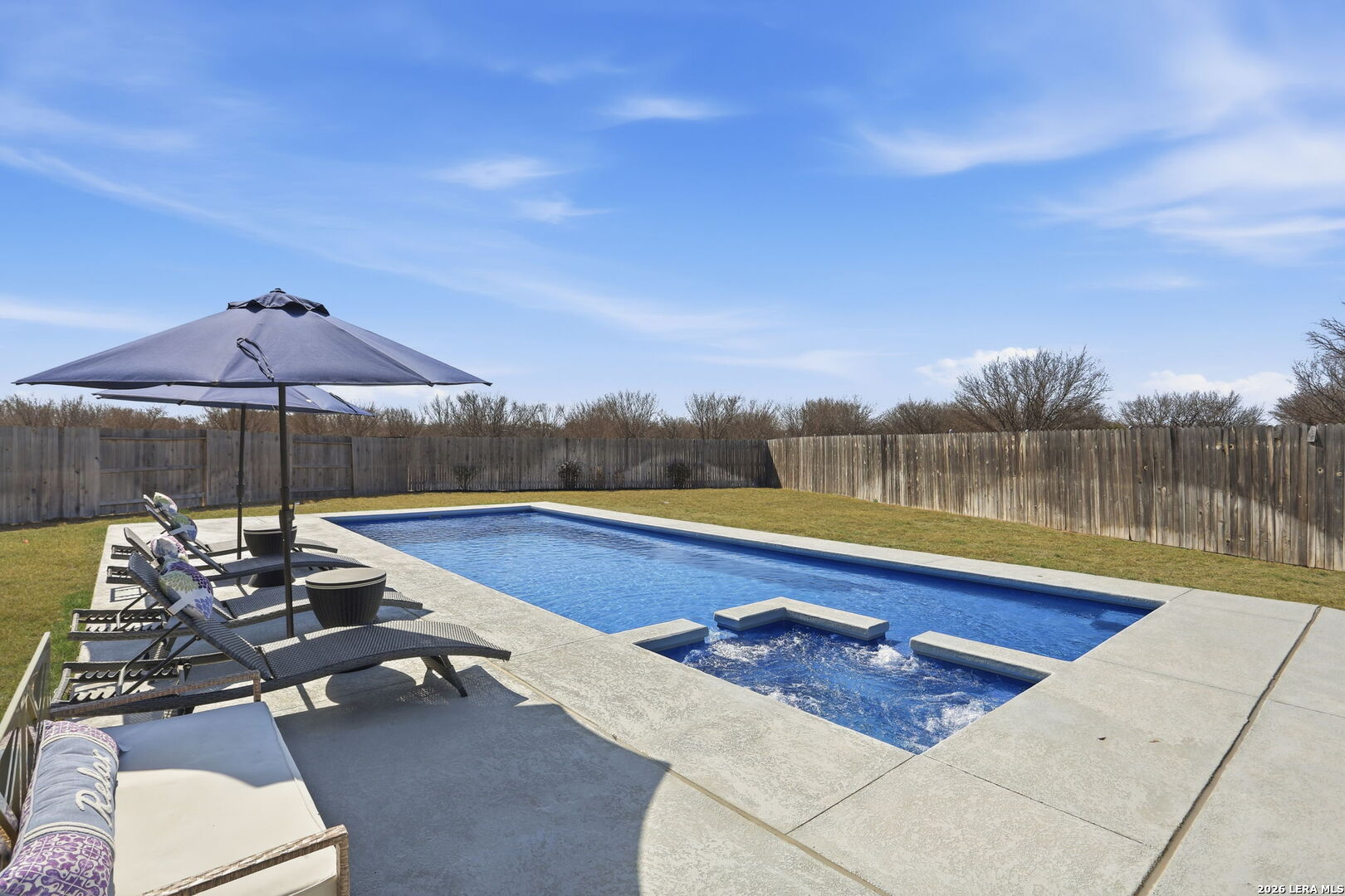 405 Corwin Cibolo, TX 78108 - Photo 35 of 46 a view of a swimming pool with a lounge chair and a lake view