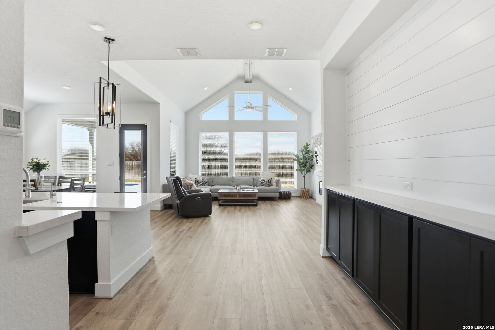 405 Corwin Cibolo, TX 78108 - Photo 9 of 46 a open kitchen with stainless steel appliances a large window and a wooden floor