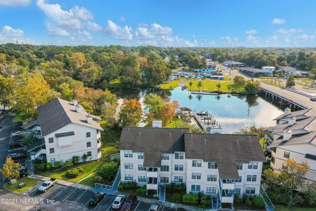 an aerial view of residential houses with outdoor space and swimming pool