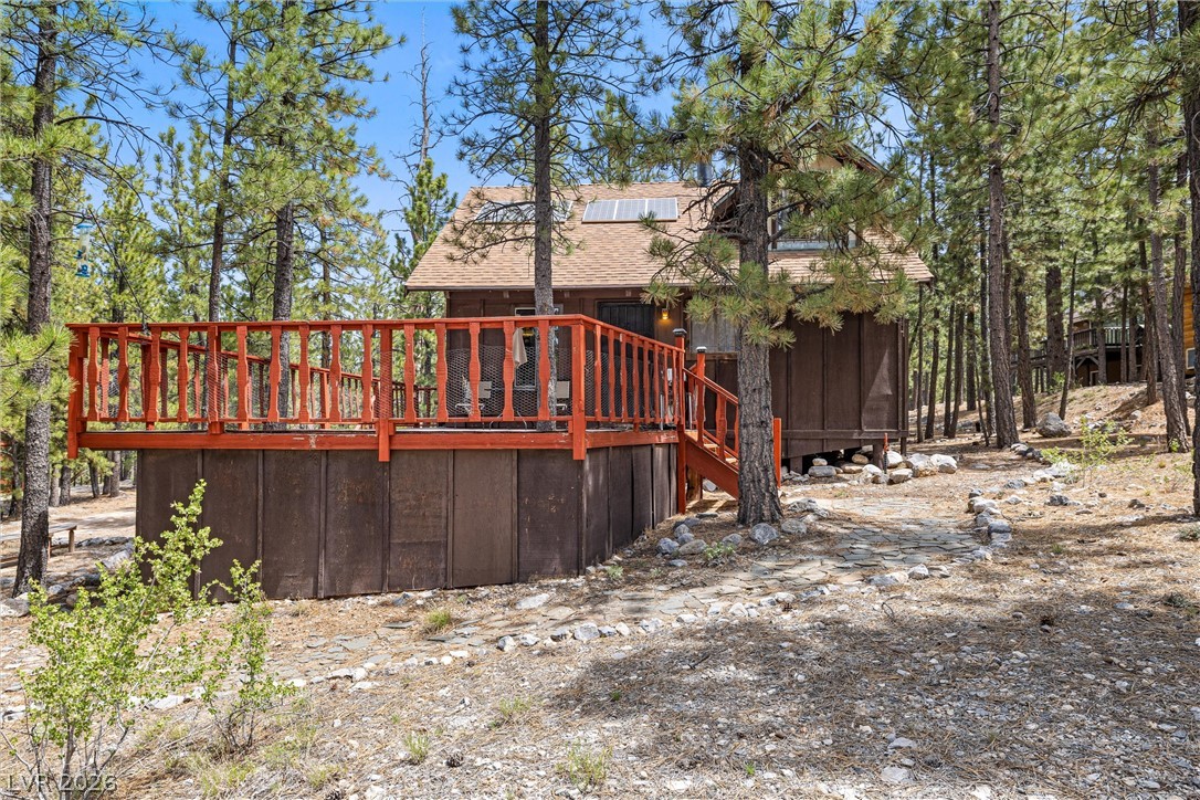 2146 Via Spes Nostra Street Mount Charleston, NV 89124 - Photo 6 of 33 Perched among towering pines, this rustic cabin offers a private deck perfect for woodland relaxation.