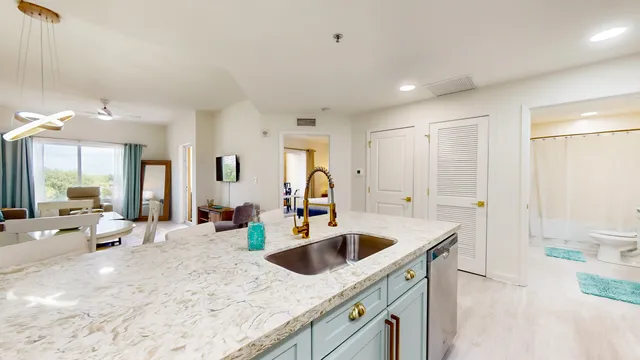 a kitchen with stainless steel appliances granite countertop a sink and a refrigerator