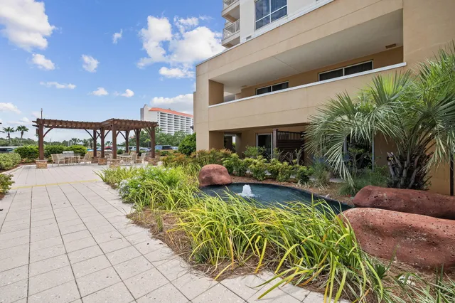 a view of a porch with chairs and potted plants