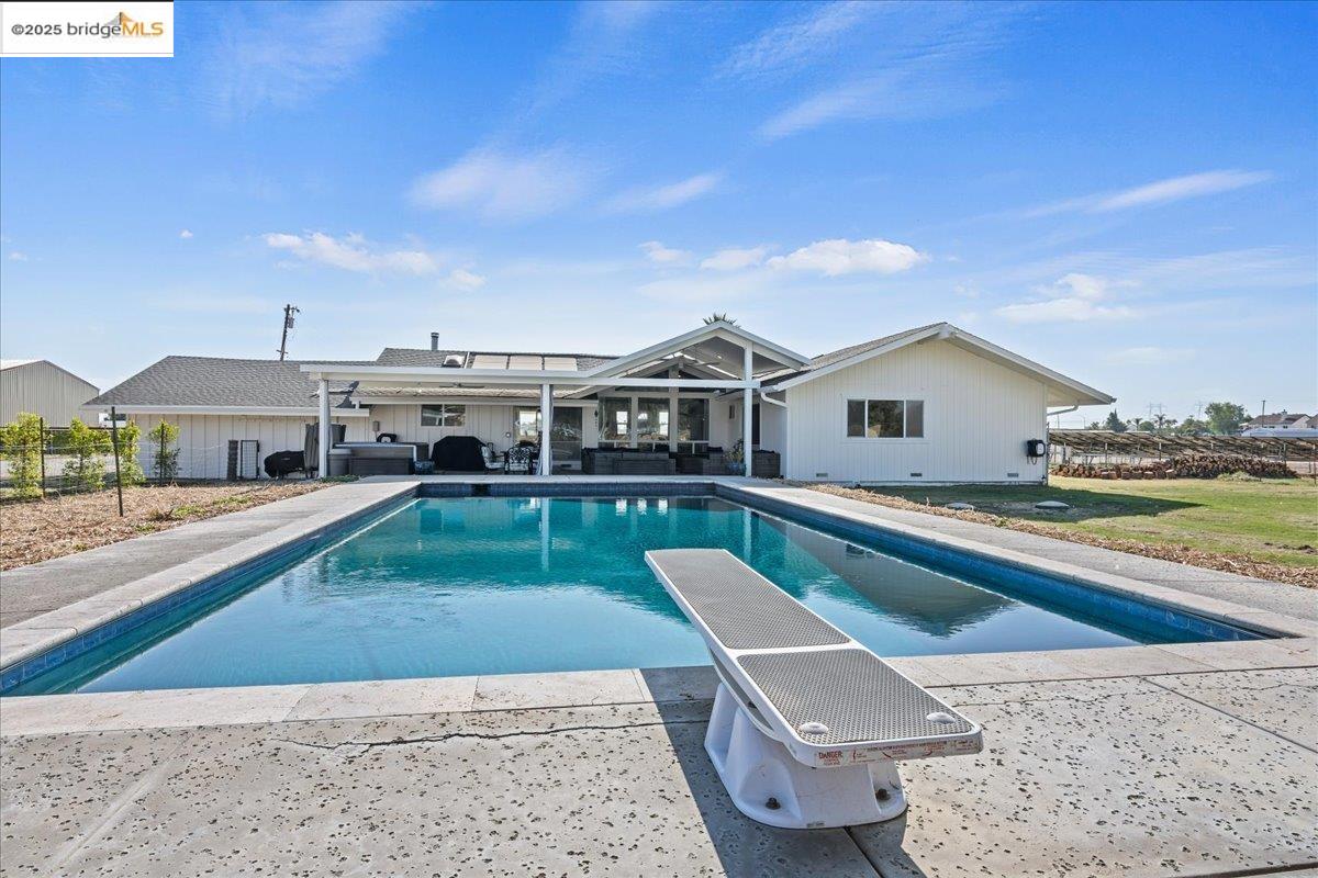 a view of house with swimming pool yard