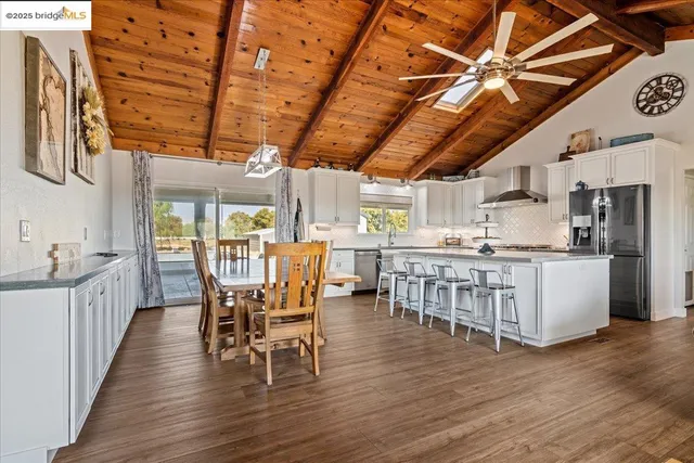 a dining room with furniture window and wooden floor