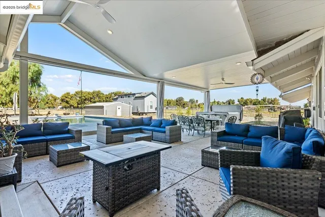 a living room with lots of furniture and a large window