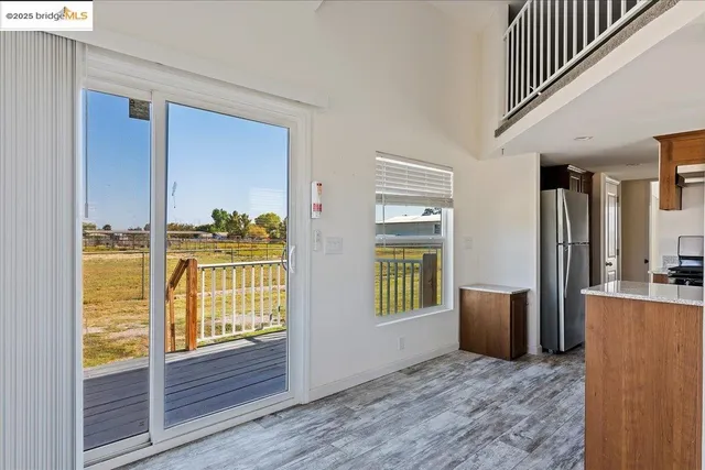 a view of an entryway with wooden floor and a livingroom