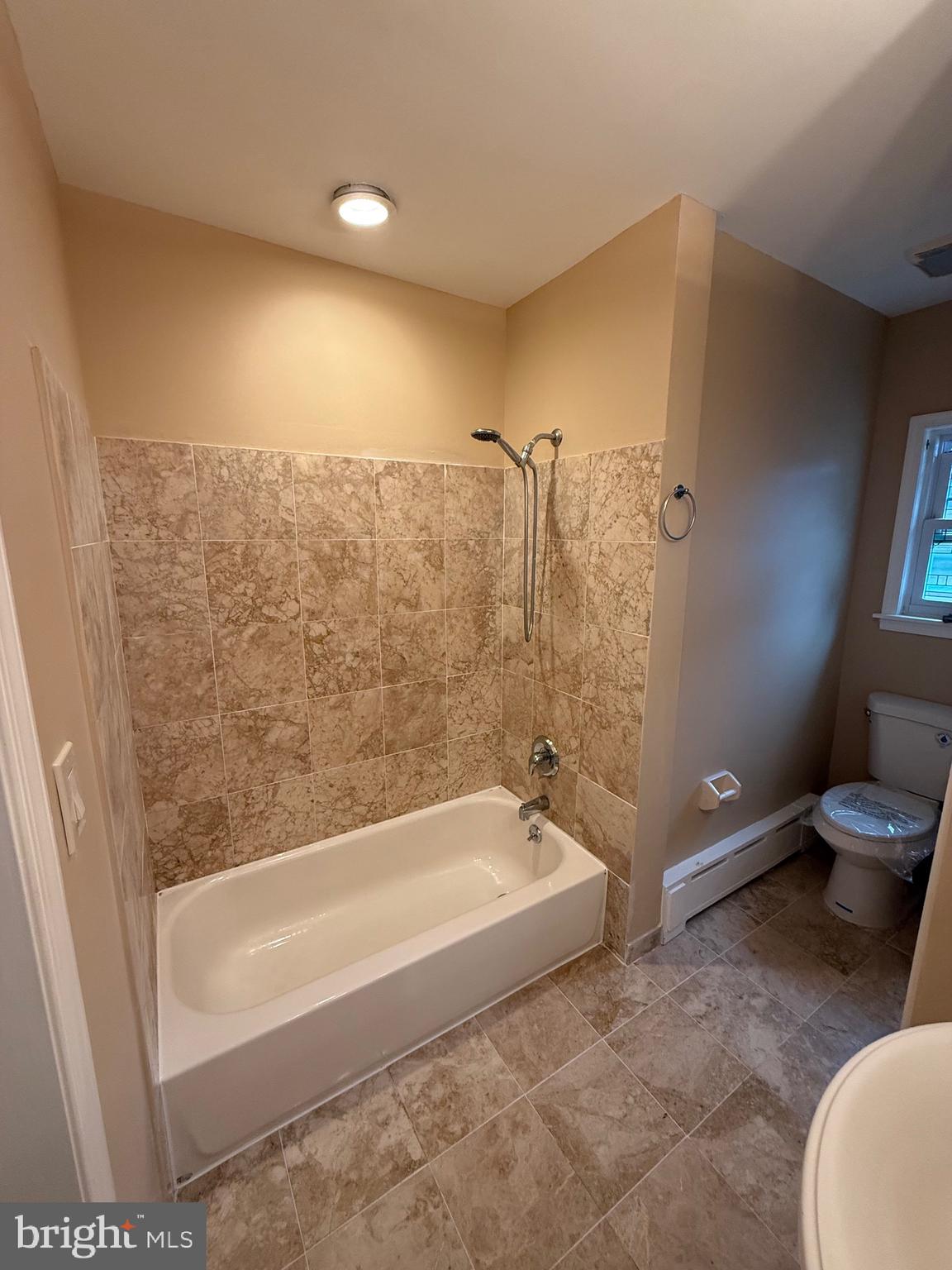 232 South Highland Road Springfield, PA 19064 - Photo 21 of 58 a bathroom with a bathtub and toilet